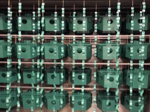 Stacks of green bio-acoustic bird deterrent devices in the workshop from Scarecrow.