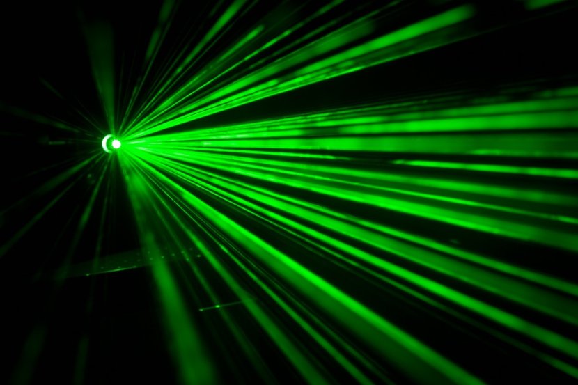 Green laser lights in darkness.